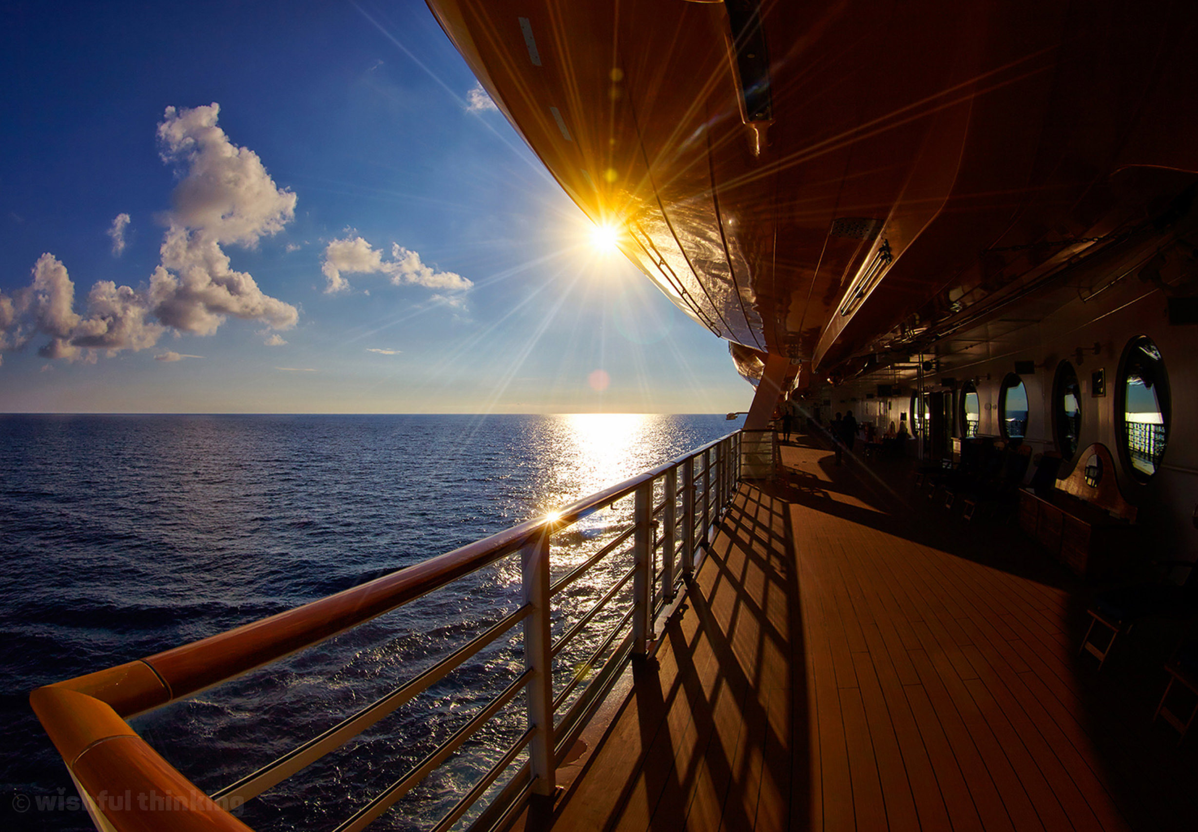 Disney Cruise Line ships soak up the golden afternoon sun as a spectacular Disney cruise sails to Castaway Cay in the Bahamas