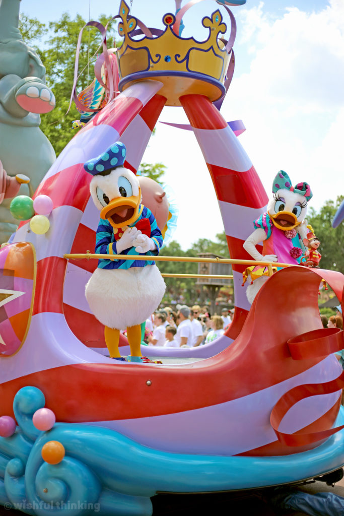 Donald Duck and Daisy Duck dance and wave to guests during the Festival of Fantasy Parade at the Magic Kingdom within Walt Disney World, Orlando, Florida