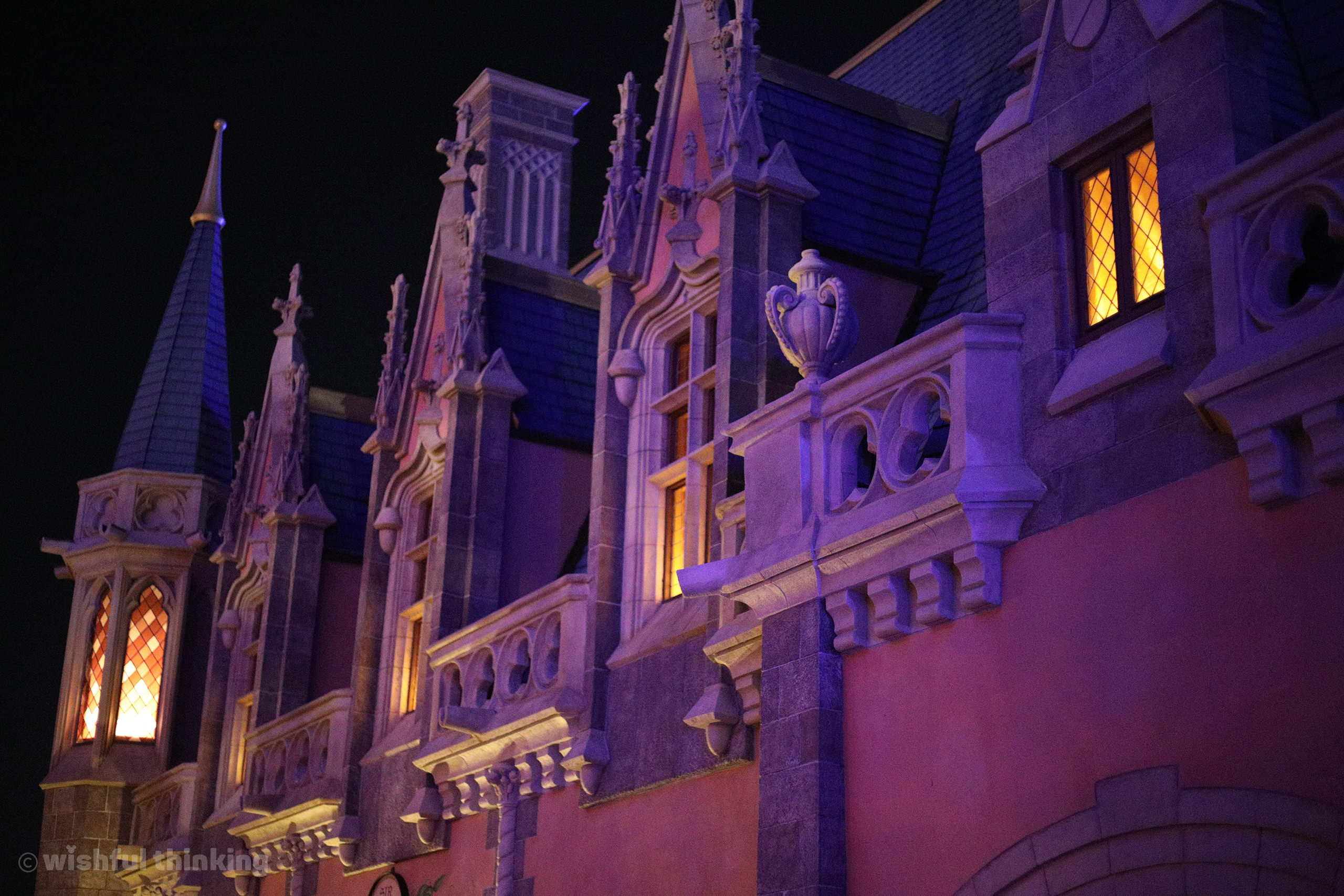Fantasyland glows from castle balconies within Fantasyland at Disney's Magic Kingdom Theme Park