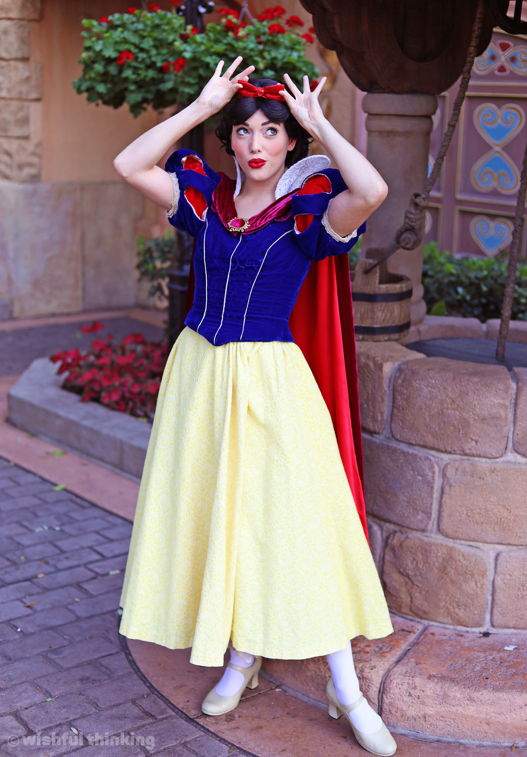 Snow White, looking lovely, shows off the bow in her hair within EPCOT's Germany Pavilion at Walt Disney World in Orlando, Florida