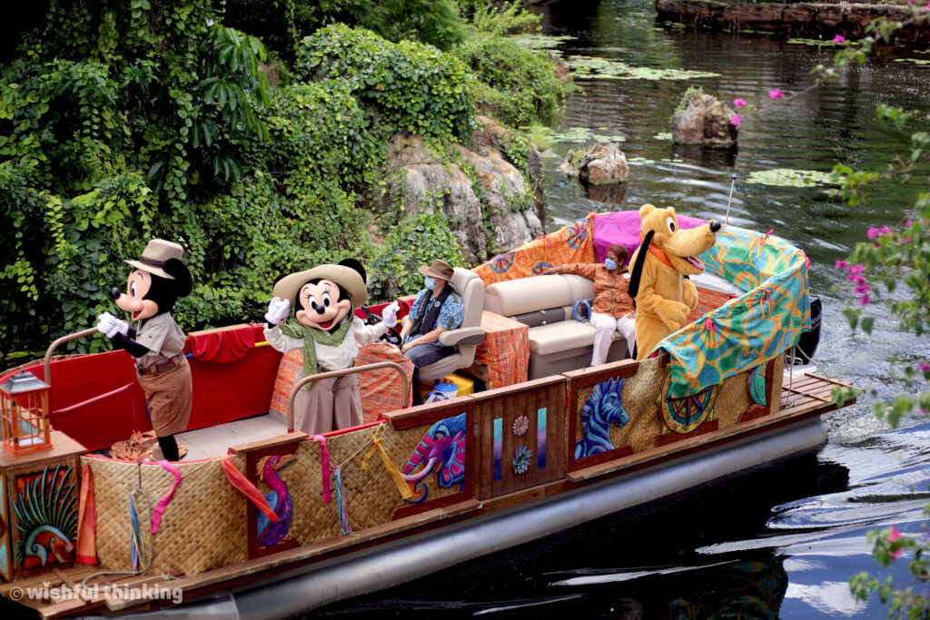 Mickey Mouse, Minnie Mouse, & Pluto sail along the Discovery River while returning from safari in Disney's Animal Kingdom at Walt Disney World in Orlando, Florida
