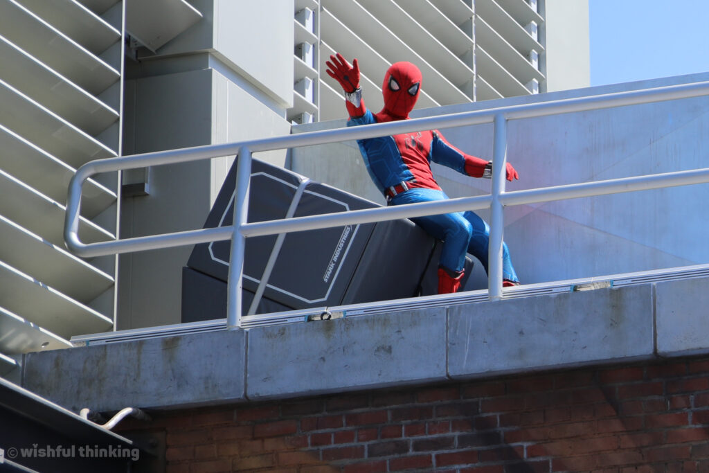 Spider-Man waves from a balcony at Avengers Campus struntronic show in Disneyland, California