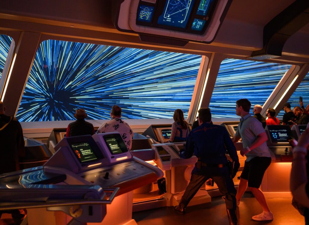 Guests on board the Star Wars Galactic Starcruiser experience warp speed from the bridge of the ship 