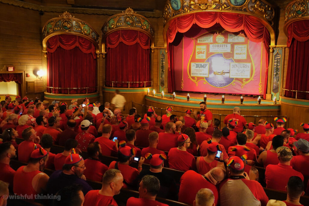 The Country Bear Jamboree at Magic Kingdom audience is full of men and women in red t-shirts celebrating Gay Days and their LGBTQ+ pride