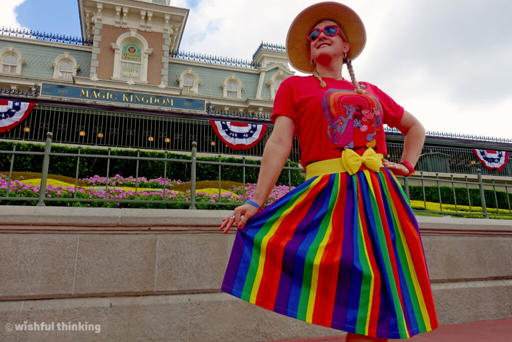 Gay Days Orlando, a smiling woman in a rainbow skirt and red tshirt shows off her fashion and pride at the Magic Kingdom in Walt Disney World, in Orlando Florida