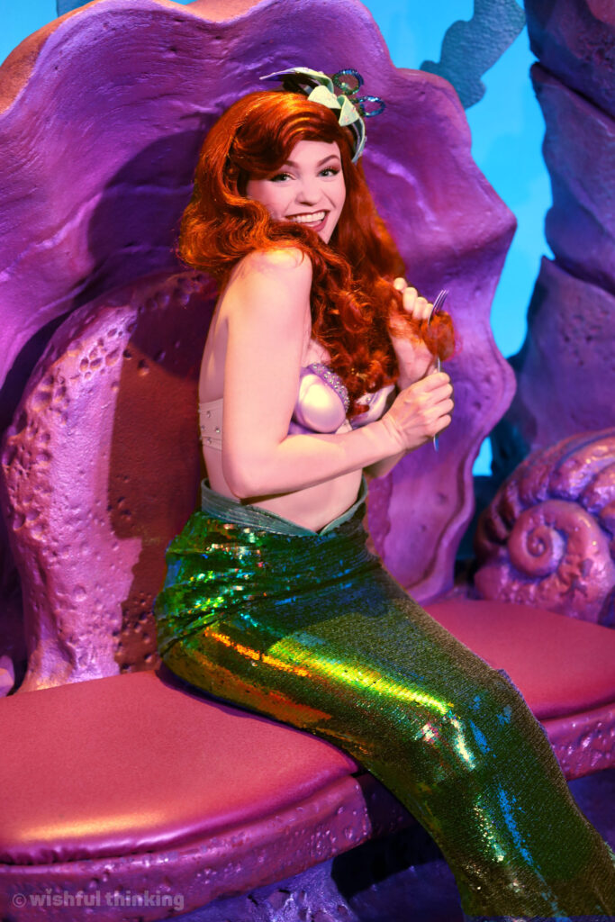 Ariel in Ariel's Grotto at Magic Kingdom combs her hair with a dinglehopper