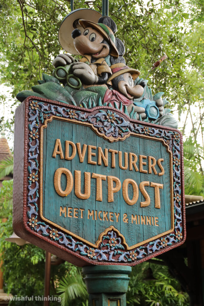 At Animal Kingdom park, a sign for Adventurers Outpost invites guests to meet MIckey and Minnie 