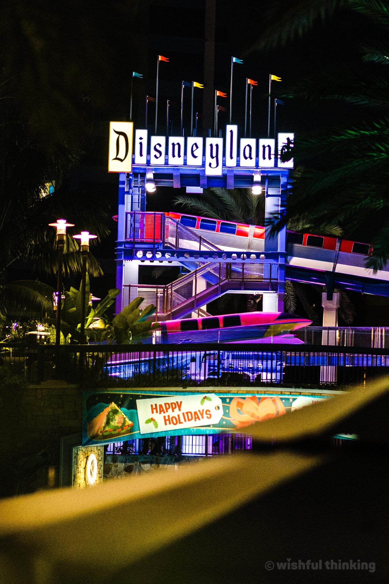 Disneyland Hotel's famous vintage monorail waterslide sign glows at night in Anaheim, California