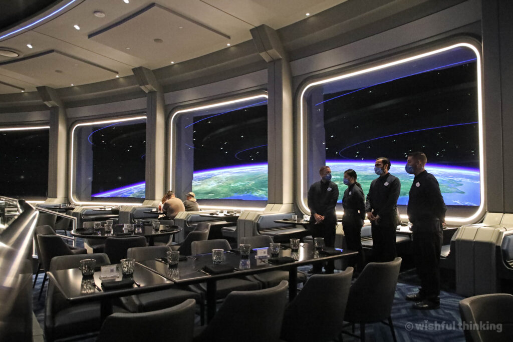EPCOT guests explore the space-age interiors of the futuristic restaurant Space 220, situated 220 miles above Earth