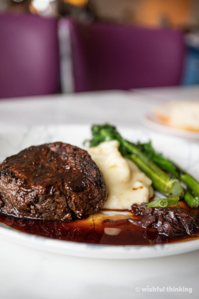 Citrico's restaurant at Disney's Grand Floridian Resort serves a steak with mashed potatoes, asparagus and red wine reduction