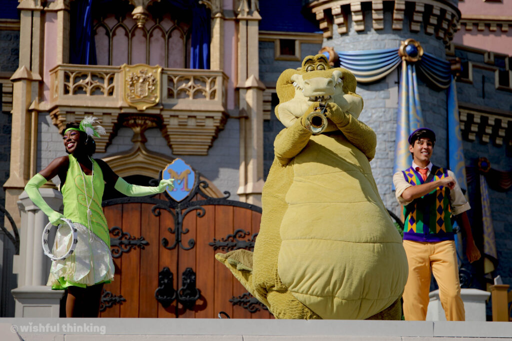 Tiana, Louis and Prince Naveen sing and dance to New Orleans Jazz during MIckey's Magical Friendship Faire at Magic Kingdom in Walt Disney World on the Cinderella Castle stage