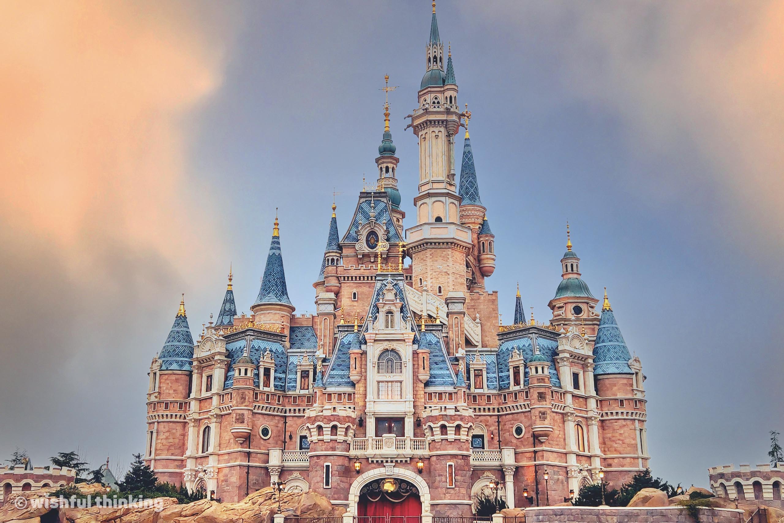 The Enchanted Storybook Castle at Shanghai Disneyland glows with late sunset pink hues in Shanghai, People's Republic of China
