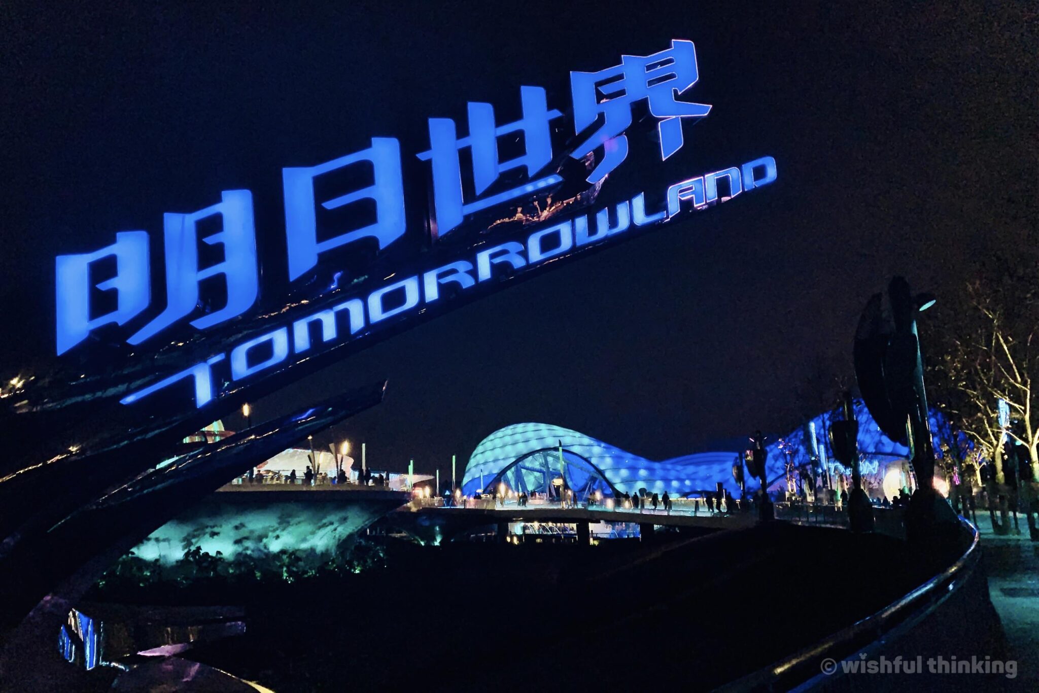 Tomorrowland in Shanghai Disneyland illuminates and glows at night, inviting guests to ride the Grid on board TRON PowerRun