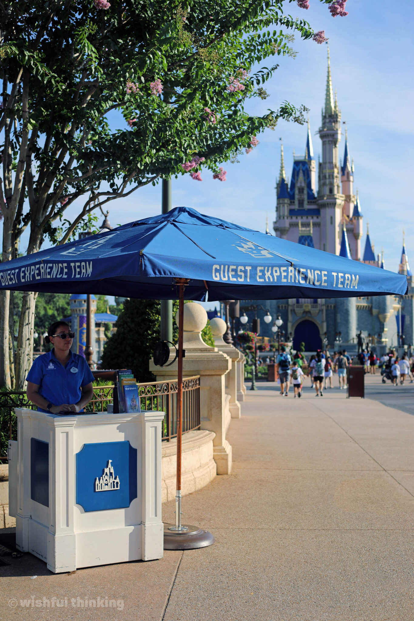 At the Guest Experience Team blue umbrella in Magic Kingdom, Disney's tech experts assist guests at Walt Disney World.