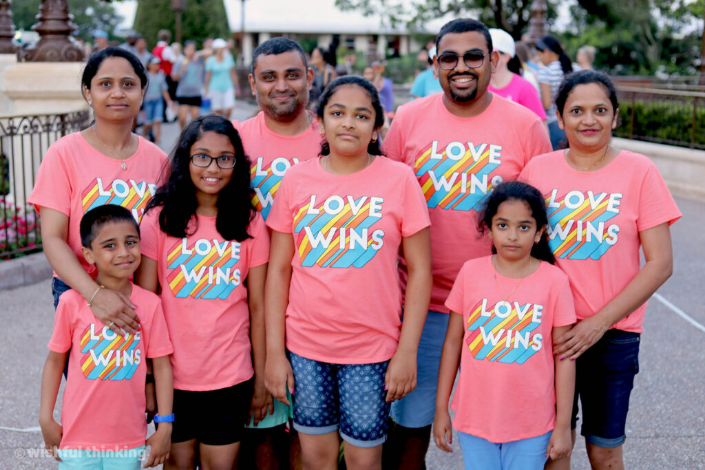 An Indian family supports their LGBTQ+ family member and hugs during the Gay Days celebration at Walt Disney World's Magic Kingdom Park
