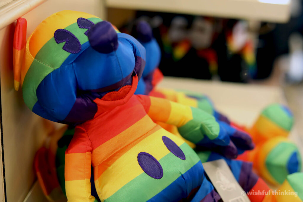 A rainbow Mickey Mouse plush doll, part of the Disney Pride merchandise line, at Walt Disney World