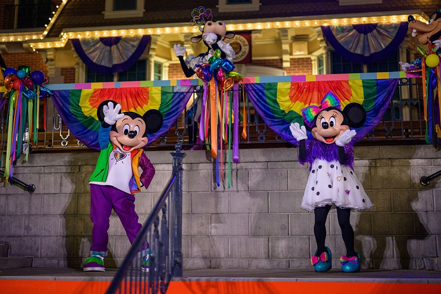 Mickey Mouse and Minnie Mouse and Clarabelle Cow greet guests at Disneyland After Dark - Pride Nite in Anaheim, California