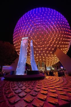 The spectrum of orange, purple, and blue lights illuminate Spaceship Earth at EPCOT during the 50th Anniversary celebration at Walt Disney World